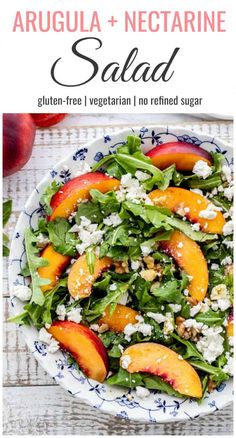 a salad with peaches and feta cheese in a bowl on top of a table