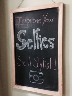 a chalk board with writing on it that says improve your selfies see a stylist