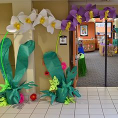 some paper flowers are on display in a room