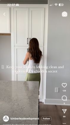 a woman standing in front of a kitchen counter