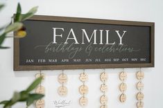 a family birthday sign hanging on the wall with wooden discs attached to it's sides