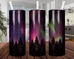 three travel mugs with the words never stop wondering over snow covered trees