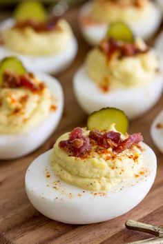 deviled eggs topped with bacon and cucumbers