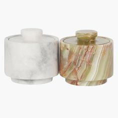 two marble jars with lids on white background