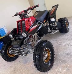 a red and black dirt bike parked in a garage