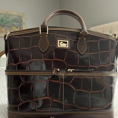 Great Condition Satchel. Very Minimally Used Beautiful Dooney And Bourke Croc Embossed Leather Handbag. Brown With Gold Tone Hardware. Pink Canvas Interior. Measurements Are 14.5" From Side To Side At Widest Point, 11" X 6.5" Across The Bottom And 10" From Center Bottom To Top. Interior Measurements, Pink Canvas, Dooney & Bourke Bags, Dooney And Bourke, Dooney & Bourke, Handbag Purse, Leather Handbag, Dooney Bourke, Brown Gold