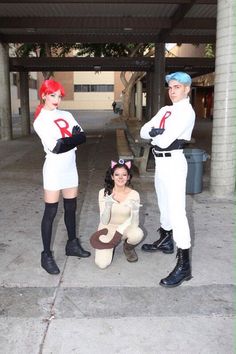 three people dressed in costumes posing for the camera