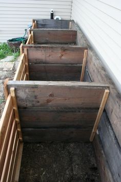 three wooden planters sitting next to each other on the side of a house,