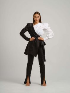 Tia Dorraine's unconventional approach to tailoring is clear to see in this statement three-piece suit that emanates elegance, coupled with a side dose of rebellious flair.  The deconstructed half blazer features a sharply defined padded shoulder, lustrous satin lapels for a tuxedo-inspired finish and a self-tie bow.  The floor-length trousers were designed in an exaggerated high-rise style featuring a belt and side pockets, delicately showing the signature pink lining.  The romantic one-shoulder shirt is constructed from cotton-blend poplin fabric and is extraordinarily designed with a puff shoulder, bishop sleeve and draping along the bust that contrasts the fitted bodice. Hand wash only. Wash inside out with like colours. Do not wring or twist. Do not tumble dry. Iron at 160°C max or us Sparkling Shoes, One Shoulder Shirt, Sparkle Shoes, High Rise Style, Slim Trousers, Gifts For New Mums, Pearl Jewellery Earrings, Slim Fit Trousers, Front End