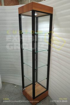 an empty display case with glass shelves on the sides and wood trimming around it