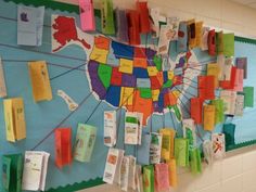 a bulletin board with colorful papers pinned to the map of the united states on it