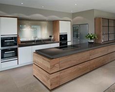 a modern kitchen with an island counter top