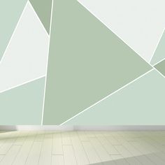 an empty room with a green and white geometric design on the wall, floor to ceiling