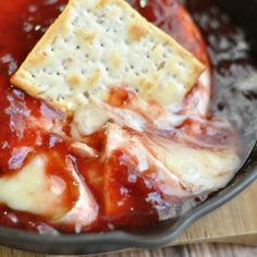 cheese and sauce in a skillet with crackers