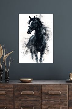 a black and white photo of a horse on a wall above a dresser with drawers