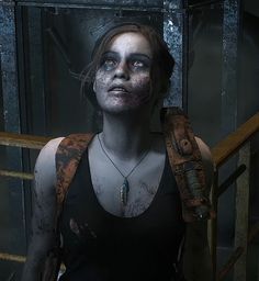 a woman with makeup and blood on her face standing in front of a metal door