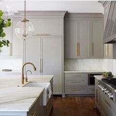 a kitchen with marble counter tops and wooden floors