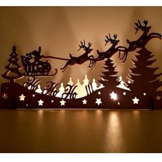 a lighted christmas scene with santa's sleigh and reindeers