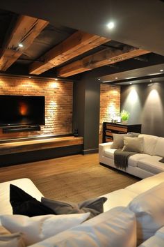 a living room filled with furniture and a flat screen tv mounted to the side of a wall