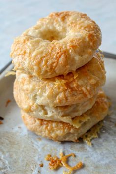 three donuts stacked on top of each other with orange peels around the edges