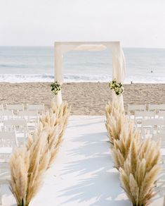 an outdoor ceremony set up on the beach