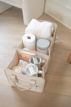 an open suitcase filled with toiletries on top of a wooden floor