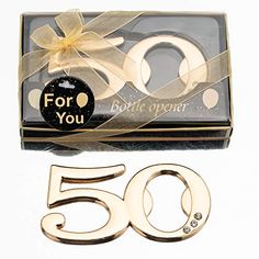 the 50th anniversary gift set is packaged in a clear box with gold ribbon and bow