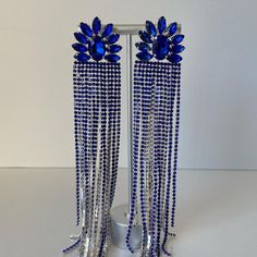 These fun, chic and fashionable blue long rhinestones earrings are a great statement piece elevating your outfit to the next level. Be ready to receive compliments and look your best!  Dimensions:  Length: Approx 8.3" Width: Approx 1.1" Select your products carefully as no returns or exchanges are accepted. This piece is in perfect condition as you see on the picture. Once chosen and approved by the customer before shipment, the order is completed. All sales are final. Contact seller should you have any questions or doubts. Seller is not responsible for lost or stolen packages.   ----------------------------------------------------------------------------------------------------------------------------------------------- Estos divertidos, elegantes y modernos aretes de diamantes de imitaci Earrings Prom, Pageant Earrings, Evening Earrings, Blue Drop Earrings, Prom Earrings, Blue Dangle Earrings, Party Earrings, Earrings Blue, Large Earrings