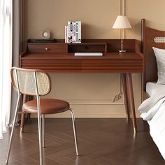 a bedroom with a bed, desk and chair next to a window in the room