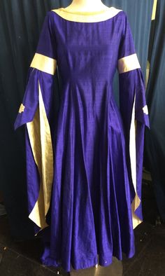 The dress in these pictures is ready to ship right away.  It has a maximum 41" bust and 30" waist. It was used in one performance  of Camelot, and has been dry cleaned, so there is a discount if this one fits you. These tend to look best if you have a little wiggle room.  This is not stretchy, and it does not lace up the back, so please check your measurements before you order. Other sizes and styles are available as a custom order which takes 6-8 weeks. We will send a measurement chart when you Elegant Fitted Blue Medieval Dress, Historical Design Fitted Long Sleeve Dress, Elegant Blue Medieval Dress, Historical Design Dress With Fitted Bodice For Fancy Dress, Royal Style Fitted Fancy Dress, Royal Fitted Dress For Formal Occasions, Fancy Dress With Historical Design And Fitted Bodice, Royal Fitted Fancy Dress, Royal Long Sleeve Costume Dresses