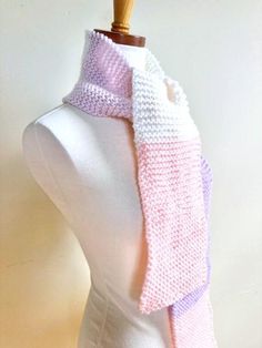 Letter sizes are an estimate- see numerical measurements and info about ease/fit below Gender neutral skinny scarf with a modern edge. Hand knit in garter stitch from hypoallergenic acrylic yarn in stripes of pink, cream, white, lavender, and peach. Can be wrapped around neck or worn open. Great neck wear for men or women. Flat actual scarf measurements: 62 inches long 6 inches wide Care instructions: Machine wash cold, air dry to preserve colors. Ease is the amount of room a garment allows the wearer beyond the measurements of their body. For example, if your waist measures 30 inches, and the waist of the garment you want to buy also measures 30 inches, it will be too tight, especially if it is made out of a non-stretch material like cotton. On the other hand, if you want to buy a knit ha Pink Knitted Scarves, Garter Scarf, Lavender And Peach, White Lavender, Pastel Stripes, Pink Lavender, Garter Stitch, Cold Air, Cream White