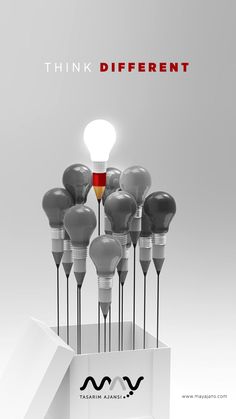 a group of light bulbs with the words think different on them in front of a white box