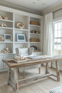 a room with some bookshelves and a desk in the middle, along with other items