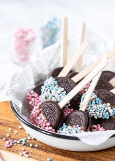 chocolate covered oreo pops with sprinkles in a bowl