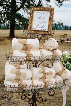 a tiered cake with lots of folded towels on it and a sign in the background