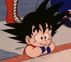 an animated image of a boy with black hair and blue shorts, leaning on a ledge