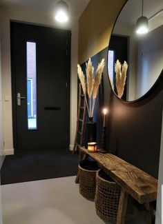 a wooden bench sitting in front of a mirror