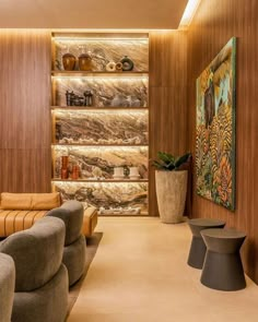 a living room filled with lots of furniture next to a wall covered in shelves and vases