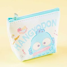 Use this cute mini pouch to store your knick-knacks! It features prints of Hangyodon with paint tubes, paintbrushes, and fruits. This zippered pouch also has a removable ball chain so you can attach charms. A kawaii zippered mini pouch decorated with Hangyodon, paint tubes, paint brushes, and fruits Comes with a removable ball chain Made of durable PVC material Original licensed product from Sanrio Japan Playful Zipper Pouch For Daily Use, Kawaii Cosmetic Bag With Zipper Pouch As Gift, Kawaii Bags With Pen Holders For Gifts, Kawaii Zipper Pouch Cosmetic Bag Gift, Kawaii Coin Purse For Daily Use, Kawaii Coin Purse Pouch For Daily Use, Playful Zipper Pouch For Personal Use, Playful Bags With Pen Slots For Everyday Use, Kawaii Daily Use Coin Purse