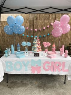 a table with balloons, cake and decorations for a boy girl baby shower or birthday party