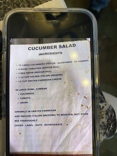 a close up of a menu on a cell phone with other items in the background