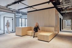 a woman sitting on a bench in an office