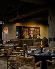 an empty restaurant with wicker chairs and tables