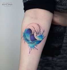 a tattoo on someone's arm that has a wave in the middle of it