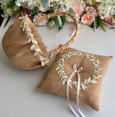 two pieces of burlock with flowers and ribbons on top of each other next to a pillow