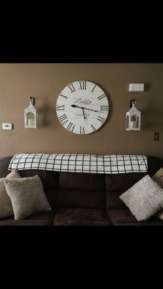 a living room filled with furniture and a large clock on the wall