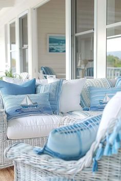 a white wicker couch sitting on top of a wooden floor next to a window