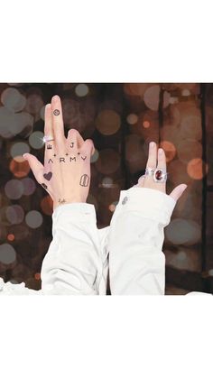 a person with their hand up in the air and two fingers raised to spell out love