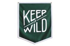 a green and white keep the wild banner