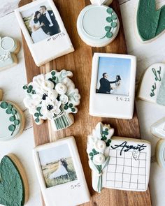 cookies decorated with photos and flowers are on a wooden board next to other cookie decorations